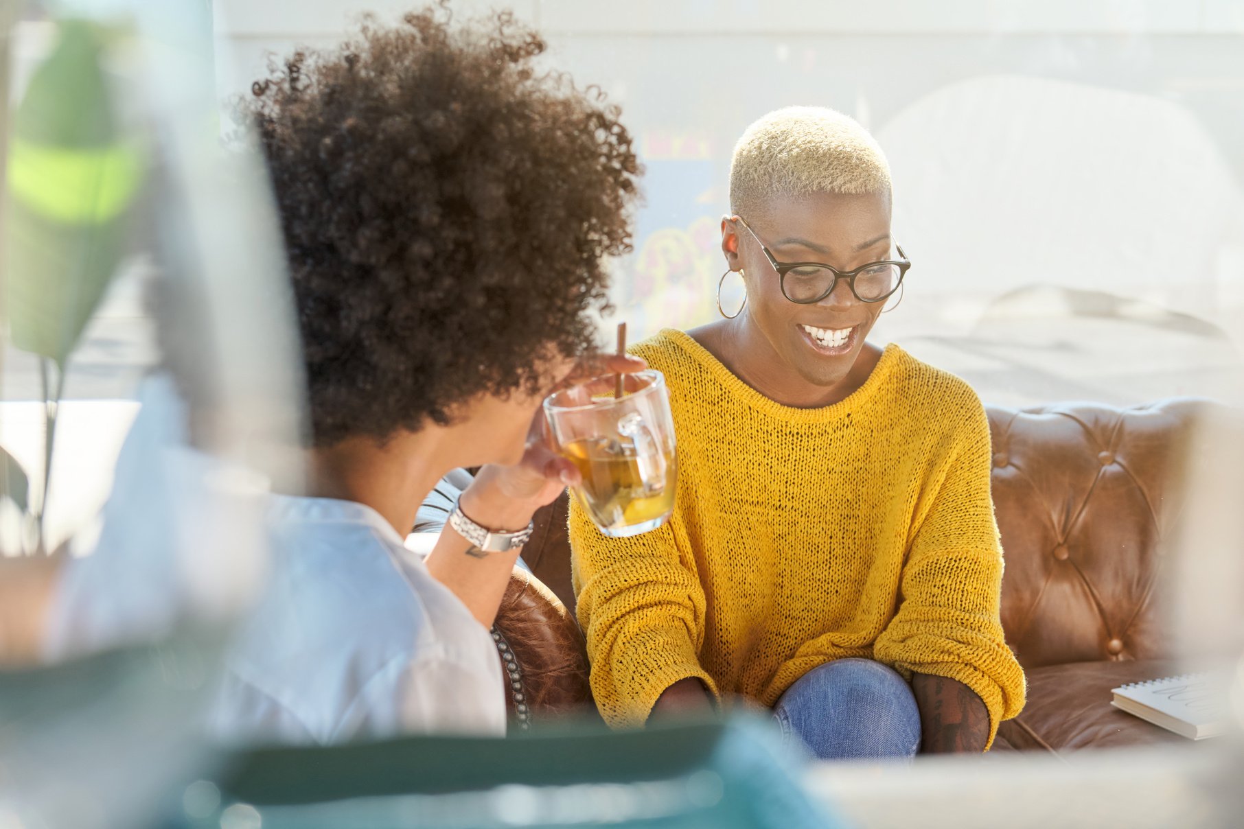 Happy black women talking at home